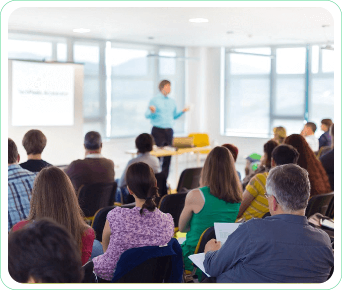 A group of people sitting in front of an instructor.