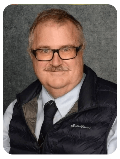 A man wearing glasses and a vest